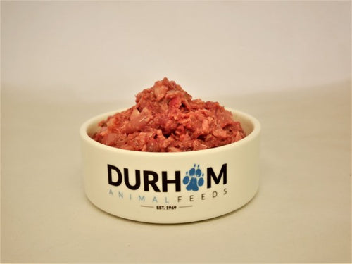 A cream coloured bowl with Durham Animal Feeds written in blue & black, filled with raw Chicken Mince.
