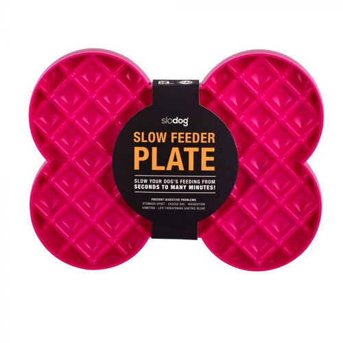 A bright pink, bone shaped plastic plate with raised square sections. There is a grey label around it, and Slow Feeder Plate is written in orange on the label.