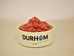 A cream coloured bowl with Durham Animal Feeds written in blue & black, filled with raw Chicken Mince.