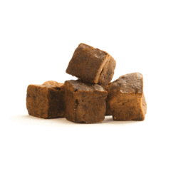 A small pile of liver brownie cubes on a white background.